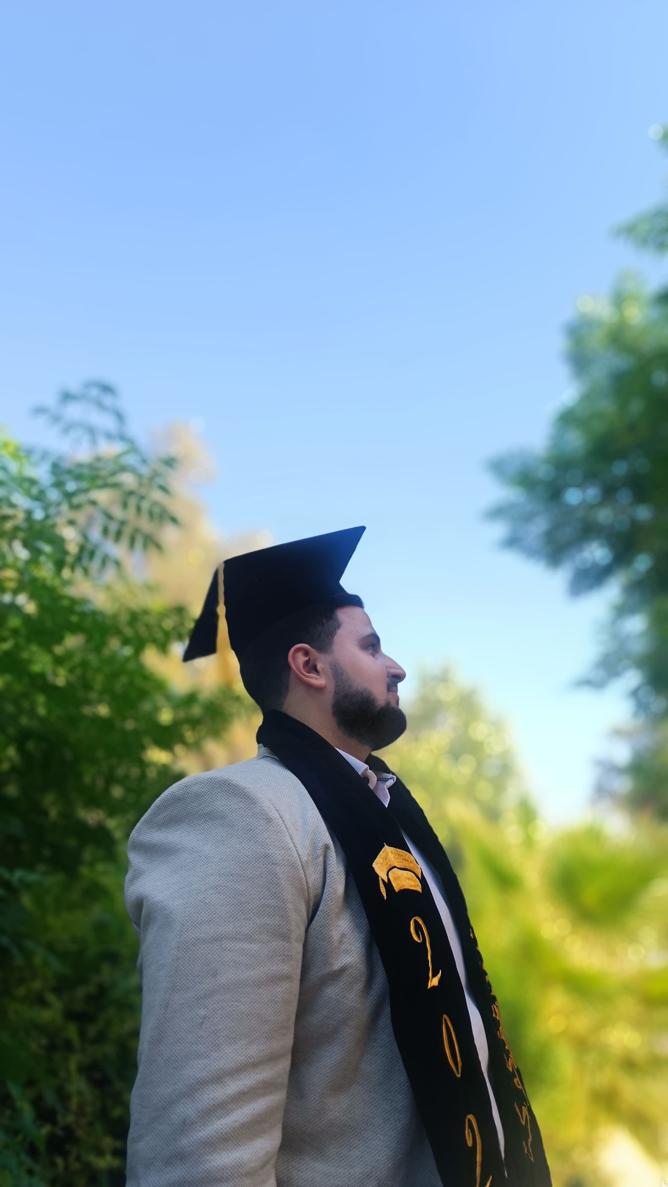 Mahmoud Kokeh wearing a graduation cap outdoors